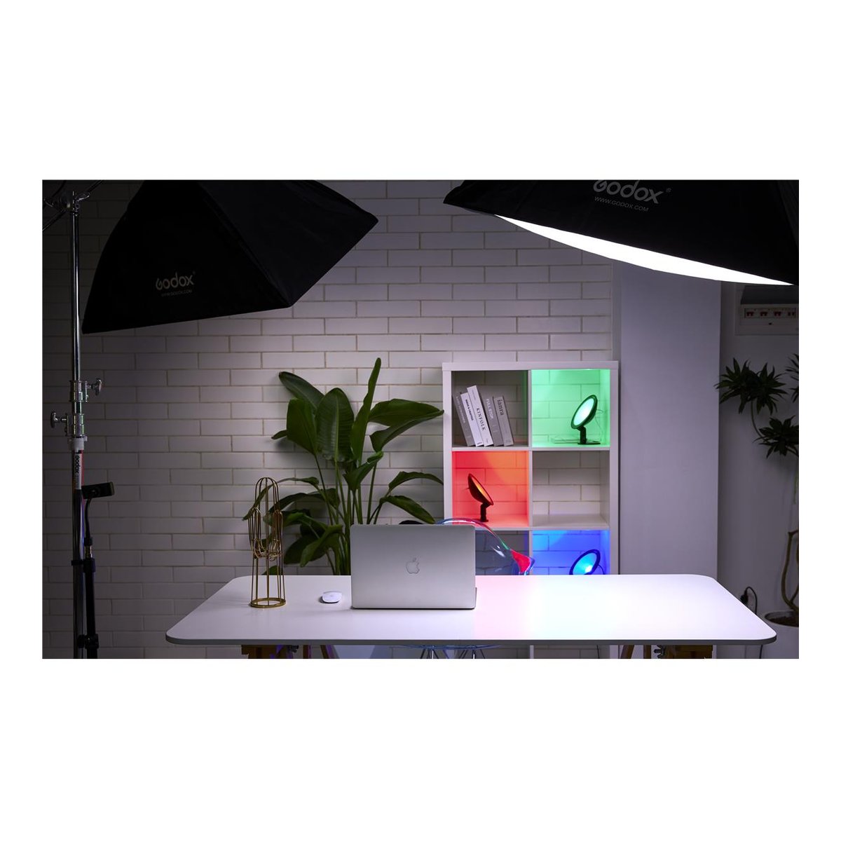Godox CL10 Ambient LED Licht - Anwendungsbeispiel: Drei farbige Lichter auf einem Regal in einem Studio-Setting mit Laptop.
