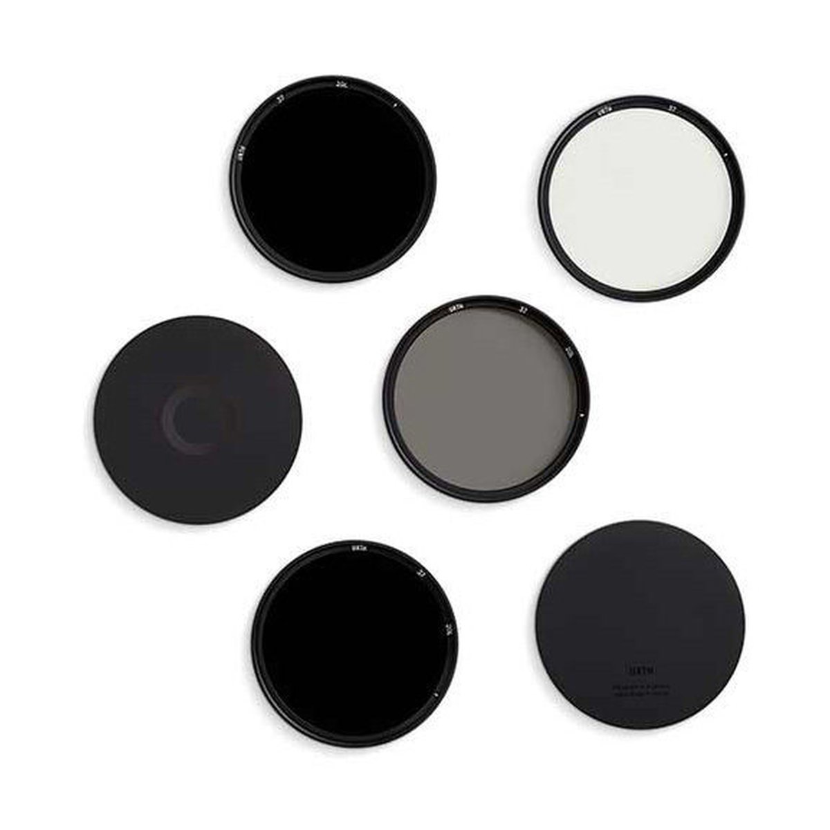 Urth 72mm Magnetic ND Selects Kit (Plus+) (ND8+ND64+ND1000) - Lieferumfang: Sechs runde Kamerafilter in verschiedenen Farben (schwarz, grau, weiß) ausgelegt.