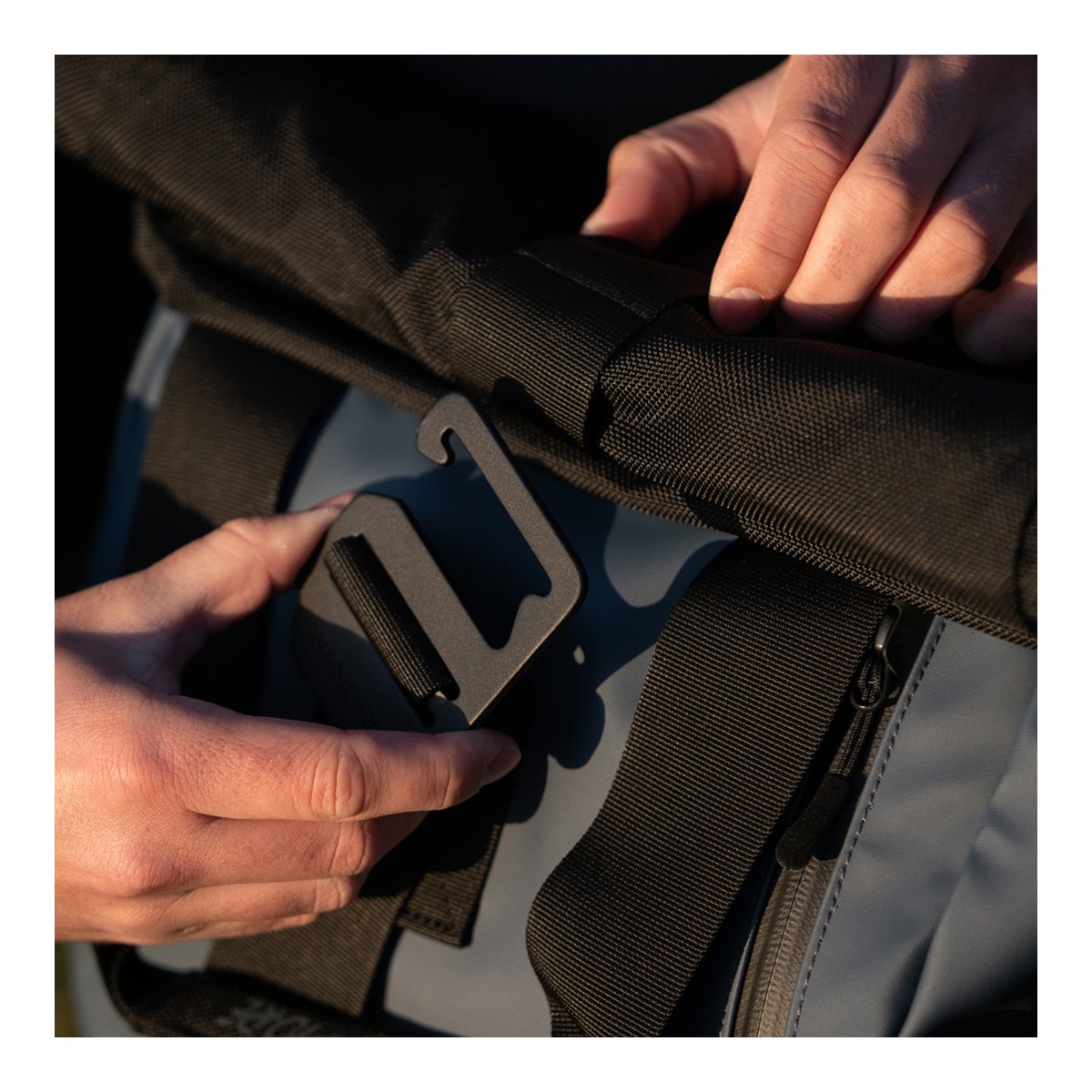 WANDRD PRVKE 31-Liter Blue V3 - Detailansicht Hakenverschluss Tasche wird bedient. WANDRD PRVKE 31-Liter Blue V3 - Detailansicht Hakenverschluss Tasche wird bedient.