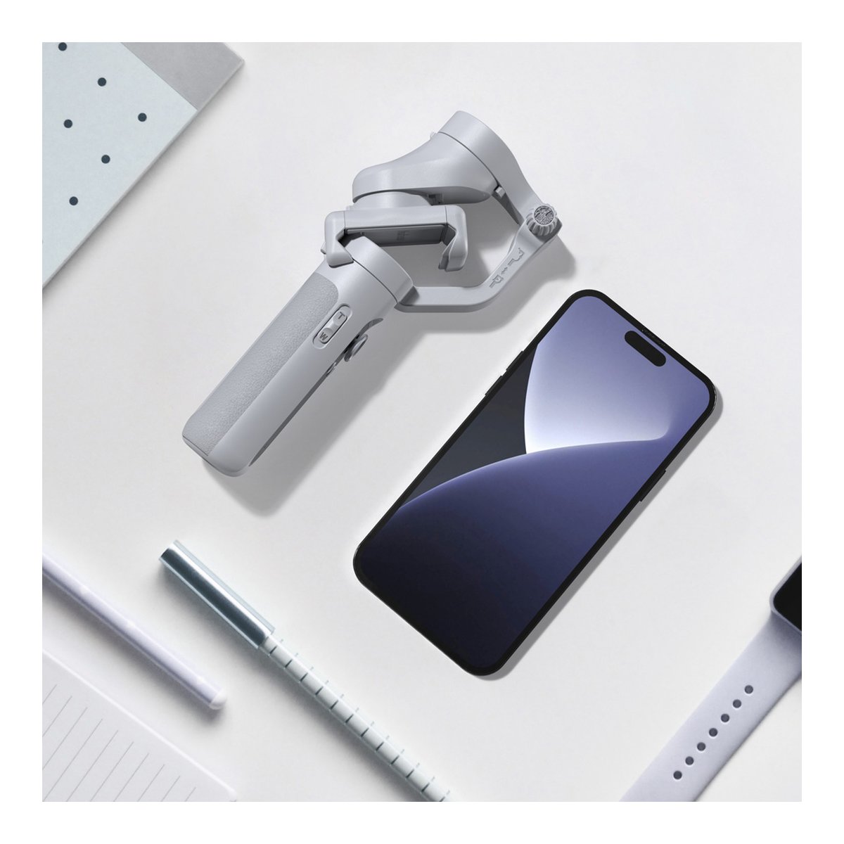 Hohem iSteady XE Black - Draufsicht: Graues Smartphone-Gimbal und schwarzes Smartphone auf hellem Hintergrund.