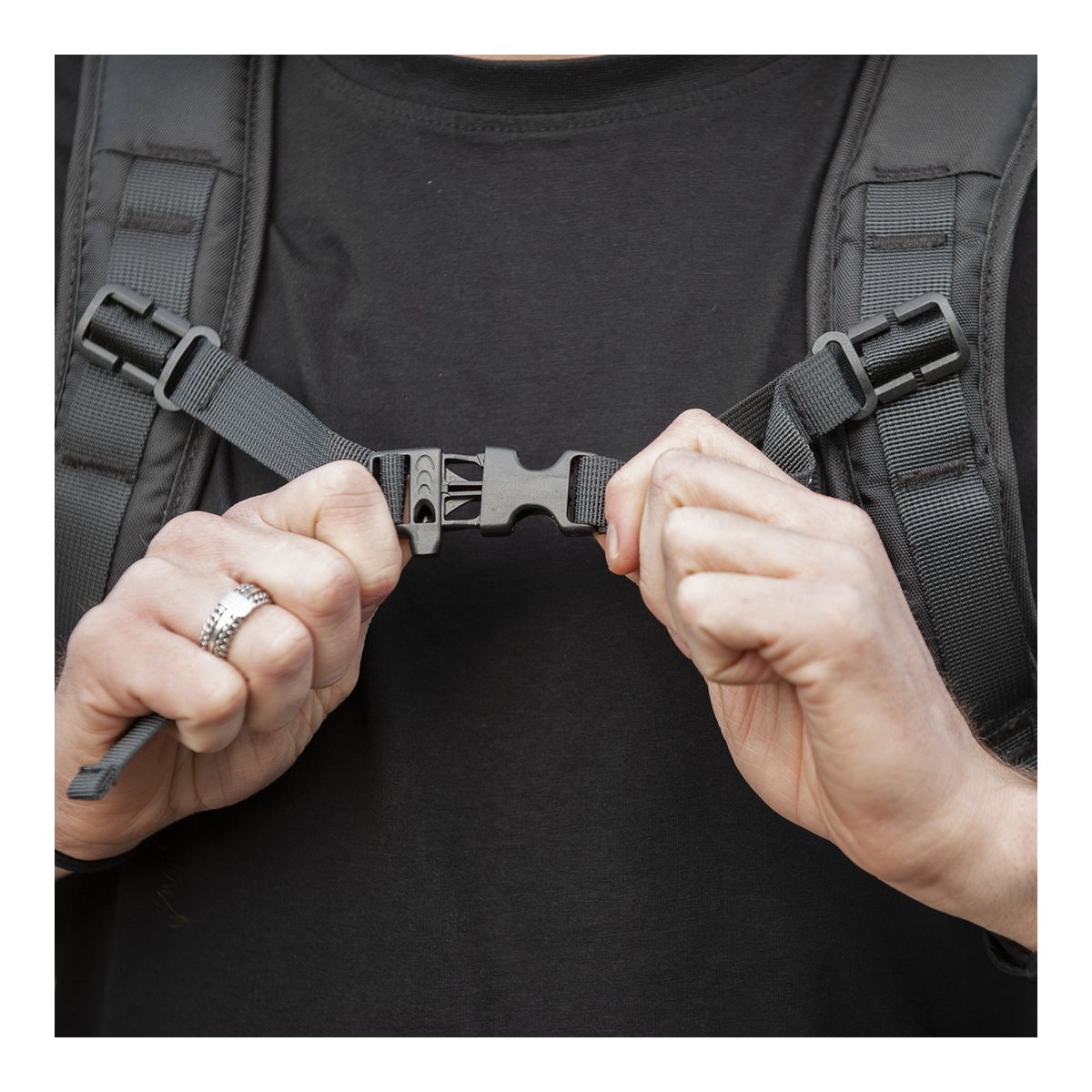 Caruba Skydex 10 - Detailansicht: Hände verbinden die Brustgurtschnalle eines Rucksacks.