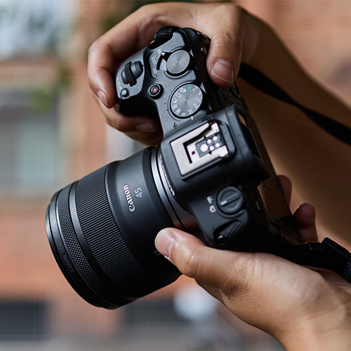 Canon EOS R Kamera mit RF 45mm 1.2 STM Objektiv wird in der Hand gehalten, ideal für Portrait und Reportage.