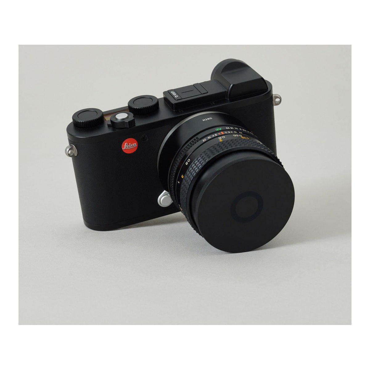 Urth 39mm Magnetic Lens Filter Caps - Vorderansicht einer schwarzen Leica-Kamera mit Objektivdeckel.