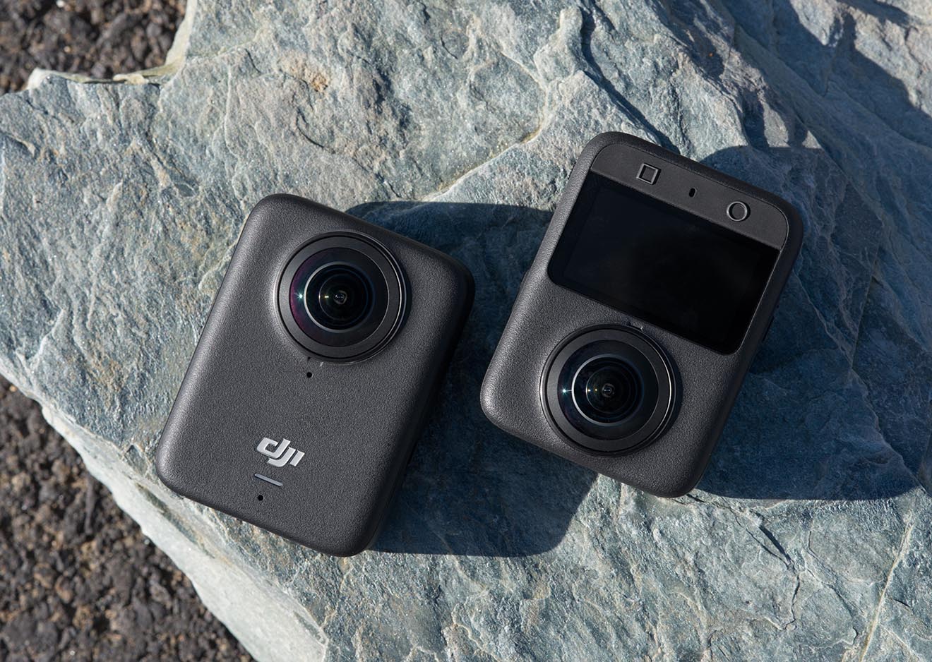 DJI Osmo 360 Vorder- und Rückseite – 360° Actionkamera im kompakten Design  Zwei DJI Osmo 360 Actioncams zeigen Vorder- und Rückseite auf einem Stein – 360° Actionkamera für Vlogging und Outdoor